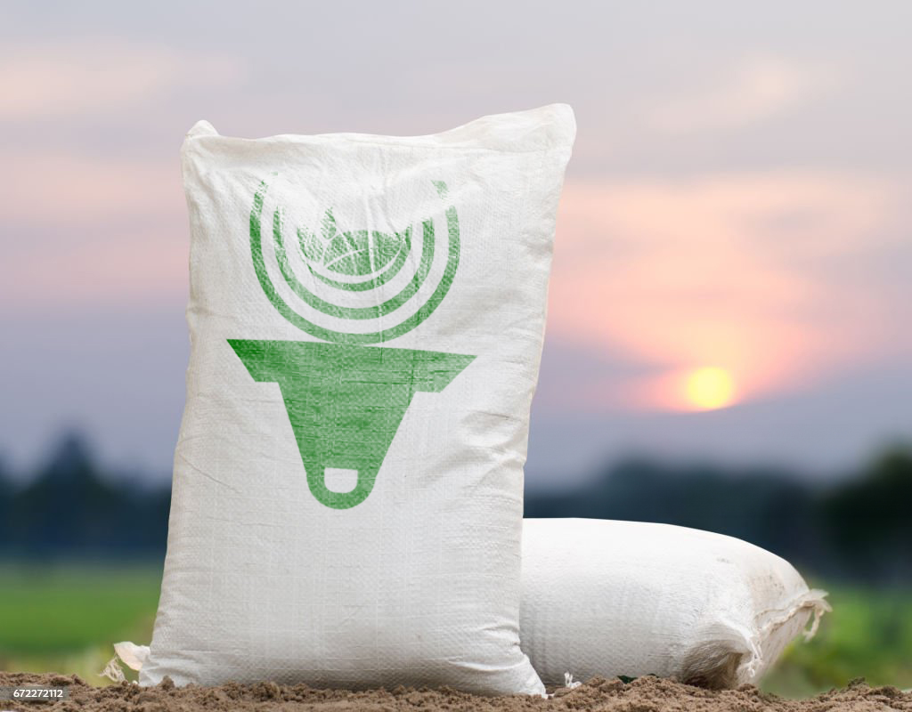 Fertilizer bag over sunrise and rice field background